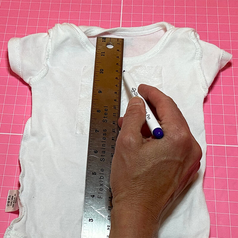 Marking center of design on wrong side of onesie
