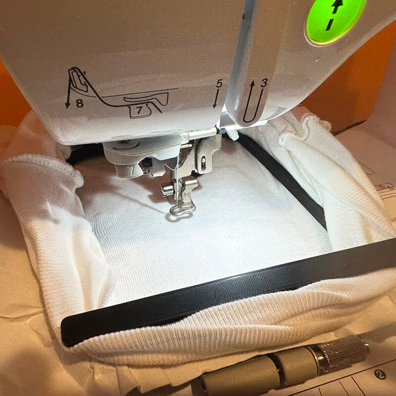 Put hoop skirt and hoop on the machine